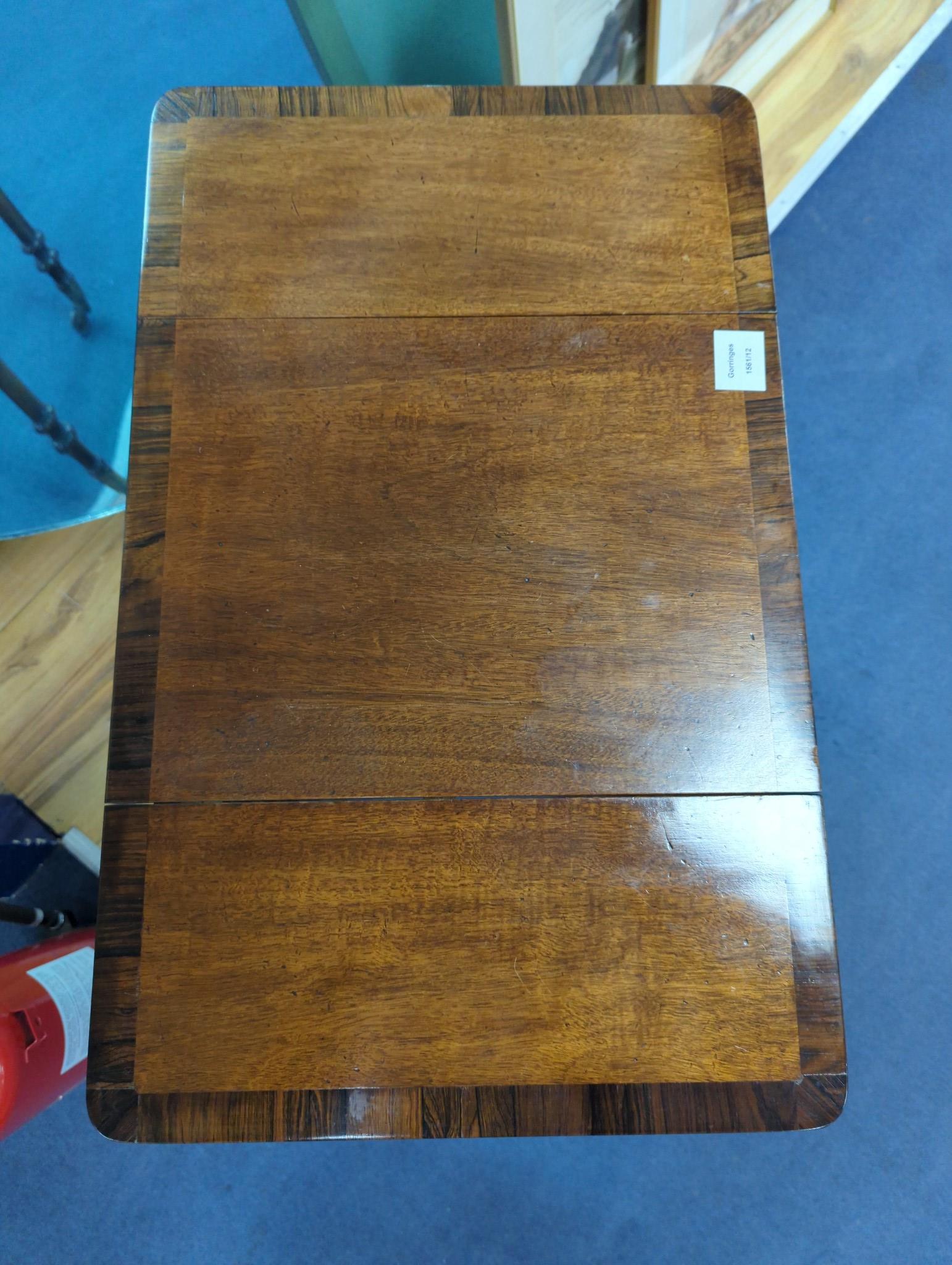An early Victorian rosewood banded mahogany drop flap work table, width 34cm, depth 41cm, height 77cm